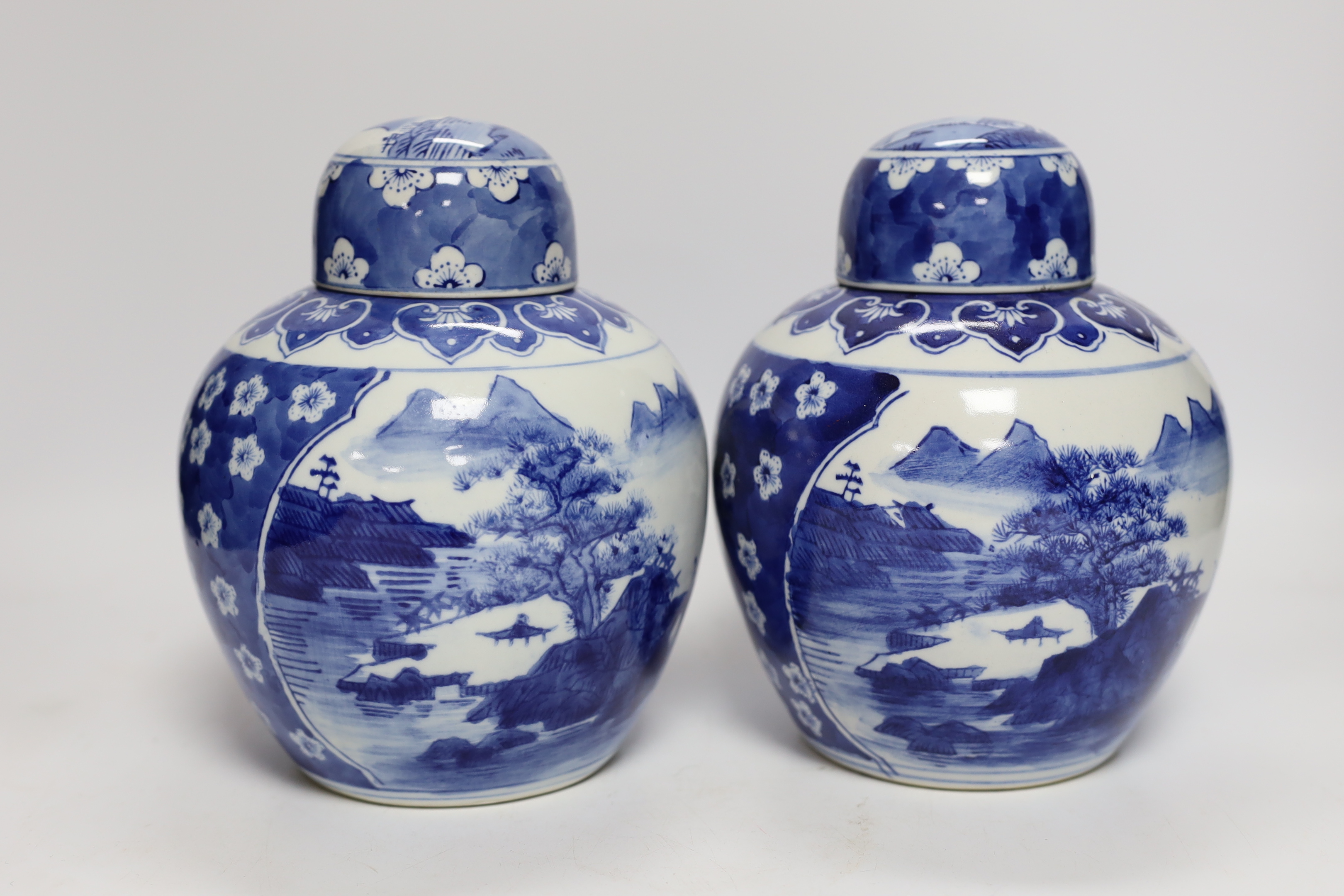 Four Chinese ginger jars, including a blue and white pair with covers and a prunus flower example, largest 21cm high